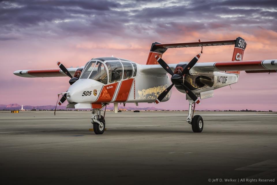 A CAL FIRE fixed wing aircraft sits on a tarmac