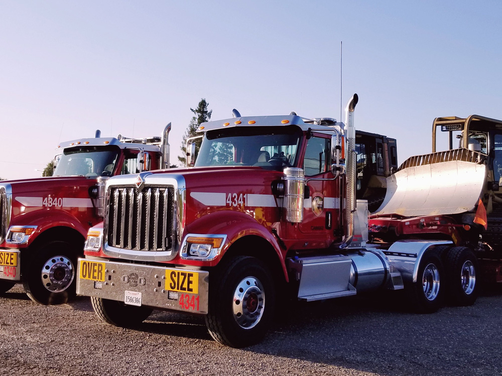 Two CAL FIRE Semi truck carrying bull dozers