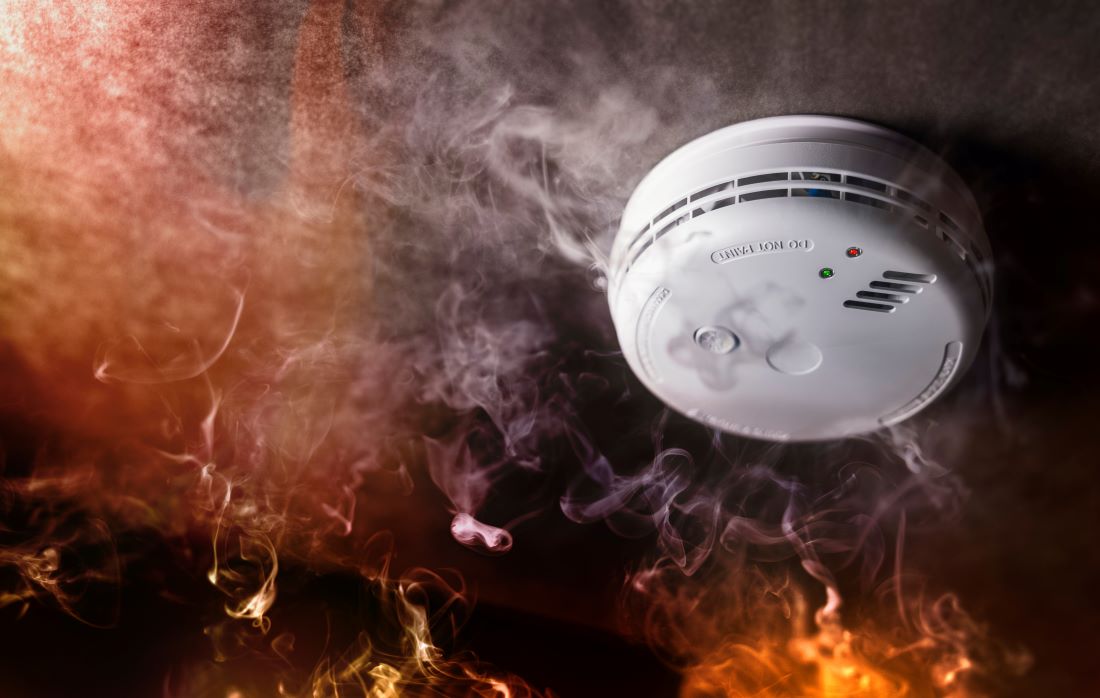 Flames and smoke near a smoke detector