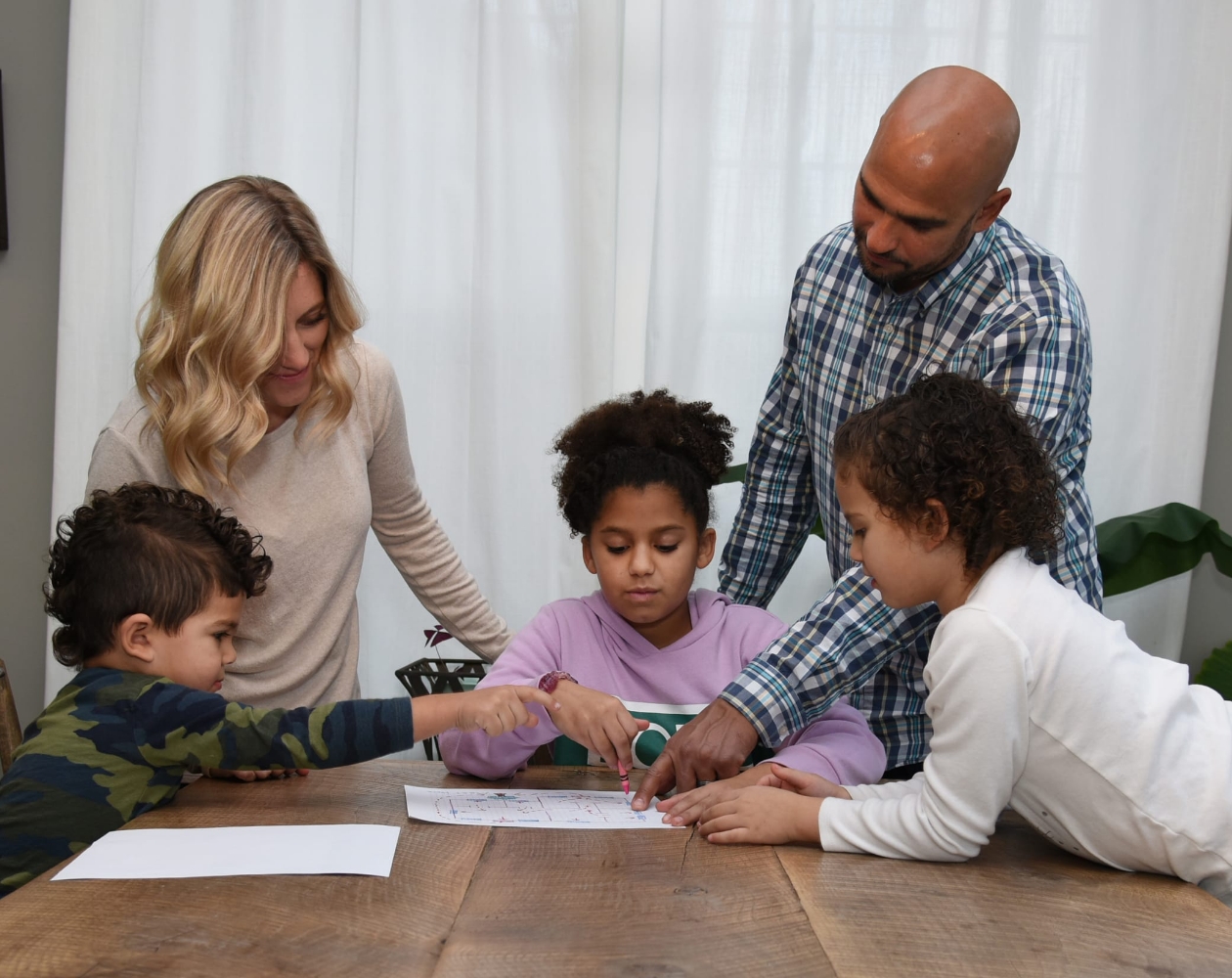 Family planning their evacuation routes at the kitchen table. 