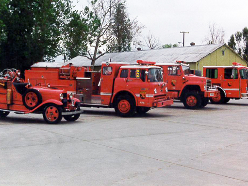 Several generations of CAL FIRE apparatus in a line