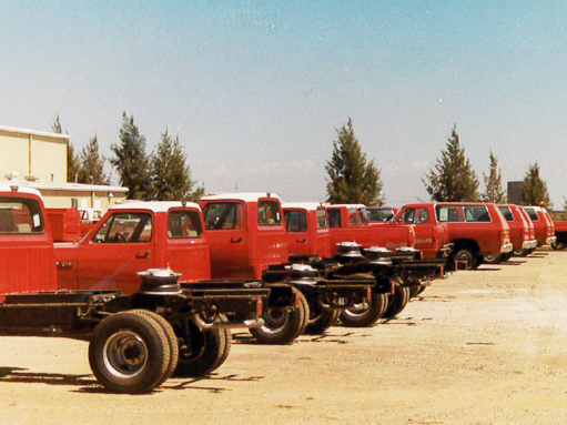 A line of up decommissioned CAL FIRE admin vehicles