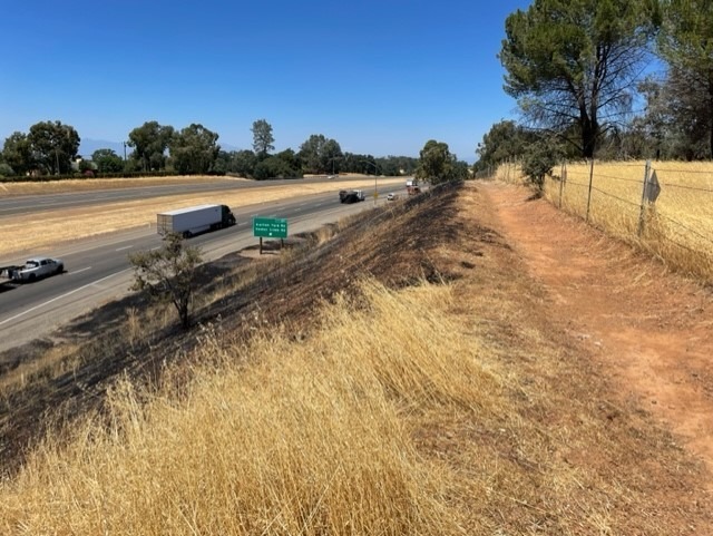 A prescribed burn and firebreak near a freeway