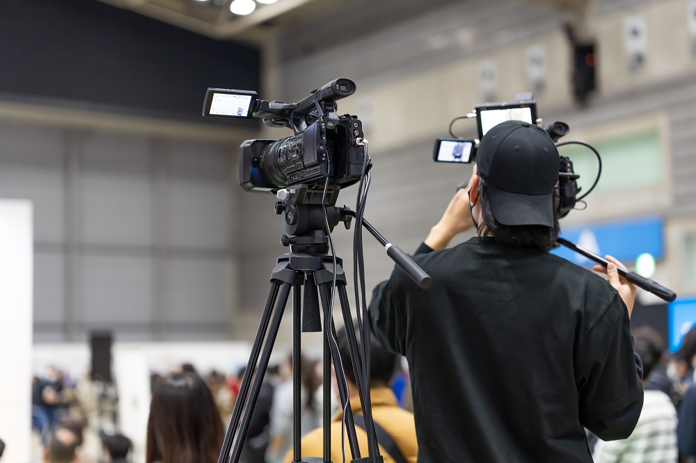 A videographer films a webinar