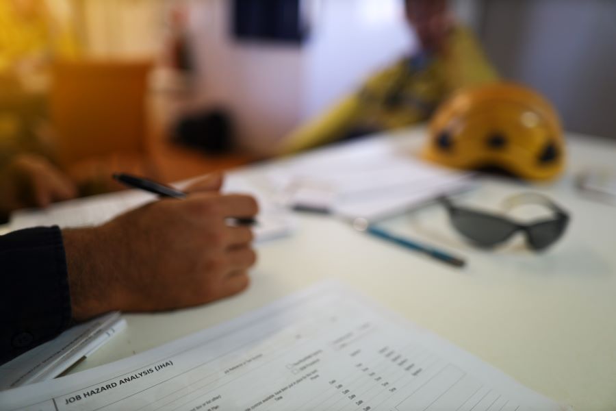 image of people reviewing document at table 