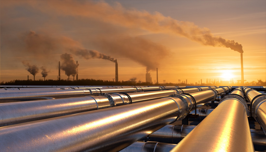 Pipelines stretch into the distance as the sun sets